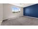 An expansive bedroom with a scenic view and a calming blue accent wall at 11847 Corenzio Ave, Las Vegas, NV 89138