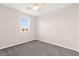 Cozy carpeted bedroom with ceiling fan and window offering natural light at 11847 Corenzio Ave, Las Vegas, NV 89138