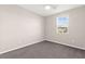 Neutral bedroom features gray carpet, ceiling fan, and window for bright and airy space at 11847 Corenzio Ave, Las Vegas, NV 89138