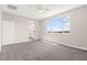 Bright, carpeted bedroom with large window offering scenic views and adjacent bathroom access at 11847 Corenzio Ave, Las Vegas, NV 89138