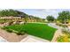 Community lawn area featuring green turf, desert landscaping, and walking paths at 11847 Corenzio Ave, Las Vegas, NV 89138