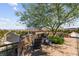 Community seating area with chairs under a shade tree, surrounded by desert landscaping at 11847 Corenzio Ave, Las Vegas, NV 89138