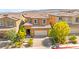 Beautiful two-story home with a well-manicured lawn, desert landscaping, and a paved driveway at 11847 Corenzio Ave, Las Vegas, NV 89138