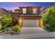 Charming two-story home features a paver driveway and a well-maintained, landscaped front yard at 11847 Corenzio Ave, Las Vegas, NV 89138