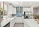 A modern kitchen featuring white cabinets, stainless steel appliances, and an island at 11847 Corenzio Ave, Las Vegas, NV 89138
