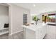 A kitchen island with white cabinets and countertops is next to an open living space at 11847 Corenzio Ave, Las Vegas, NV 89138