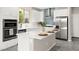 A modern kitchen featuring white cabinets, stainless steel appliances, and a stylish island at 11847 Corenzio Ave, Las Vegas, NV 89138