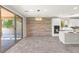 Open-concept kitchen with stainless steel appliances, island, and stylish modern backsplash at 11847 Corenzio Ave, Las Vegas, NV 89138