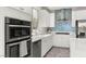 A modern kitchen with stainless steel appliances, white cabinets, and sleek countertops at 11847 Corenzio Ave, Las Vegas, NV 89138