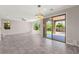 Spacious living room featuring large windows, a modern chandelier, and access to the patio at 11847 Corenzio Ave, Las Vegas, NV 89138