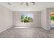 Open living area with large windows, natural light, and tile floors at 11847 Corenzio Ave, Las Vegas, NV 89138