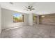 Open living room featuring large windows, natural light, and ceiling fan at 11847 Corenzio Ave, Las Vegas, NV 89138