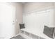 Mudroom with built-in bench, storage, and decorative pillows at entry at 11847 Corenzio Ave, Las Vegas, NV 89138