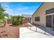 View of the home's backyard from the side, showing dog run and hardscape at 1212 E Rome Blvd, North Las Vegas, NV 89086