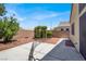 Spacious backyard featuring concrete patio, rock landscaping, and a charming garden trellis at 1212 E Rome Blvd, North Las Vegas, NV 89086