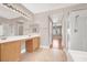 Bathroom with double sink vanity, large mirrors and glass enclosed shower at 1212 E Rome Blvd, North Las Vegas, NV 89086