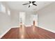 Bright bedroom with wood-look floors, a ceiling fan, and doorways to other rooms at 1212 E Rome Blvd, North Las Vegas, NV 89086