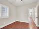 Bright bedroom featuring wood floors, a window with shutters and doors to other rooms at 1212 E Rome Blvd, North Las Vegas, NV 89086