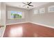 Inviting bedroom with hardwood floors, multiple windows and ceiling fan at 1212 E Rome Blvd, North Las Vegas, NV 89086