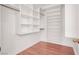 Organized walk-in closet with built-in shelving and hardwood floors at 1212 E Rome Blvd, North Las Vegas, NV 89086
