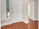 Welcoming entryway featuring wood-look floors and a bright window with white shutters at 1212 E Rome Blvd, North Las Vegas, NV 89086