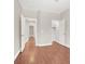 Neutral hallway featuring wood floors with doors leading to rooms and a walk-in closet at 1212 E Rome Blvd, North Las Vegas, NV 89086