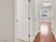 Hallway featuring wood floors with doors opening into a bedroom and other rooms at 1212 E Rome Blvd, North Las Vegas, NV 89086