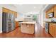 Kitchen with stainless steel appliances, an island, wood cabinetry, and tile backsplash at 1212 E Rome Blvd, North Las Vegas, NV 89086