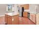 Well-equipped kitchen featuring an island, stainless steel appliances, and light wood cabinetry at 1212 E Rome Blvd, North Las Vegas, NV 89086