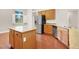 Kitchen island and stainless steel refrigerator with wooden cabinets at 1212 E Rome Blvd, North Las Vegas, NV 89086