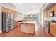 Open kitchen with a large island, stainless steel appliances, and hardwood floors throughout at 1212 E Rome Blvd, North Las Vegas, NV 89086