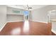 Open-concept living room featuring hardwood floors, windows, sliding glass doors and a ceiling fan at 1212 E Rome Blvd, North Las Vegas, NV 89086