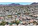 Extensive aerial view captures a charming suburban area with cozy houses, tree-lined streets, and community amenities at 130 Park Ridge Ln, Henderson, NV 89002