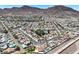 Expansive aerial view of a neighborhood with mountain views, swimming pools and well-maintained landscaping at 130 Park Ridge Ln, Henderson, NV 89002