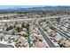 Sweeping aerial shot presenting an organized community with modern homes, well-kept streets, and lush green spaces near a highway at 130 Park Ridge Ln, Henderson, NV 89002