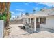Backyard featuring a covered patio, gravel landscaping, and an outdoor seating area at 130 Park Ridge Ln, Henderson, NV 89002