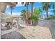 Backyard featuring a covered patio, gravel landscaping, and palm trees at 130 Park Ridge Ln, Henderson, NV 89002