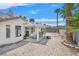 Backyard featuring a covered patio, gravel landscaping, and mature palm trees at 130 Park Ridge Ln, Henderson, NV 89002