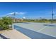 Well-maintained basketball court with hoops and seating surrounded by trees and green spaces at 130 Park Ridge Ln, Henderson, NV 89002