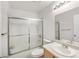Bathroom featuring a single sink vanity, shower and toilet with a frosted shower door at 130 Park Ridge Ln, Henderson, NV 89002
