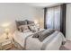 Bedroom with neutral decor and bedding, side tables, and bright window with dark drapes at 130 Park Ridge Ln, Henderson, NV 89002