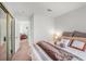 Bedroom with doorway to bonus room, mirrored closet doors, and neutral decor and bedding at 130 Park Ridge Ln, Henderson, NV 89002