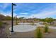 Community park featuring a splash pad, picnic shelters, walking paths, and other recreational amenities at 130 Park Ridge Ln, Henderson, NV 89002