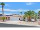 Charming single-story home featuring mature palm trees, a two-car garage, and low maintenance desert landscaping at 130 Park Ridge Ln, Henderson, NV 89002