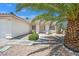 Inviting front of home with desert landscaping, sidewalk and decorative plants offers great curb appeal at 130 Park Ridge Ln, Henderson, NV 89002
