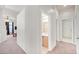 Hallway with views to the bathroom and bonus room, with neutral carpet, trim and paint at 130 Park Ridge Ln, Henderson, NV 89002
