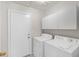 Functional laundry room features a washer, dryer, and convenient storage cabinets at 130 Park Ridge Ln, Henderson, NV 89002