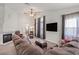 Bright living room with a cozy fireplace, comfortable seating, and large windows, perfect for relaxation at 130 Park Ridge Ln, Henderson, NV 89002