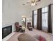 Sunlit living room featuring a fireplace, comfortable recliners and plush carpeting at 130 Park Ridge Ln, Henderson, NV 89002
