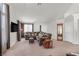 Spacious living room boasts ample seating, neutral tones, and abundant natural light from large windows at 130 Park Ridge Ln, Henderson, NV 89002